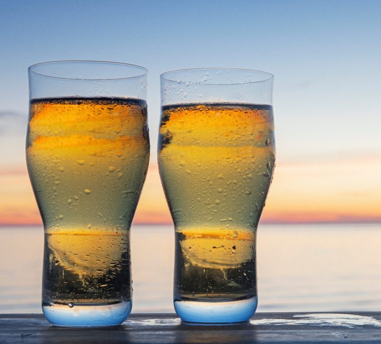 Two glasses of cider at sunset